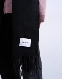 Model wearing Simone supersoft blanket scarf in black