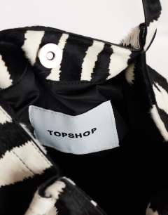 Model wearing Singer medium real hair on leather shoulder bag in zebra
