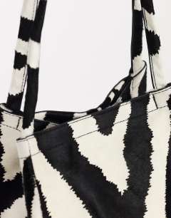 Model wearing Singer medium real hair on leather shoulder bag in zebra