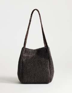 Model wearing Singer medium weave shoulder bag in chocolate