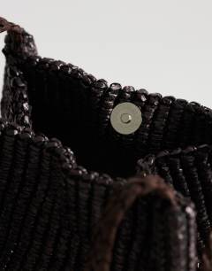 Model wearing Singer weave shoulder bag in chocolate