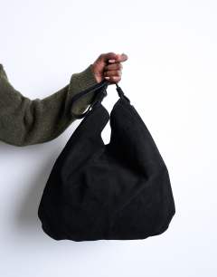 Model wearing Siobhan real suede leather shoulder bag in black