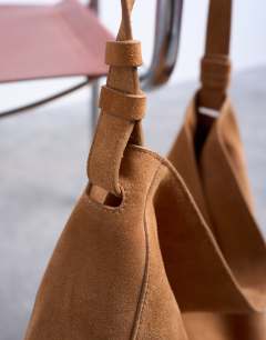 Model wearing Siobhan real suede leather shoulder bag in tan