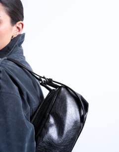 Model wearing Siris buckle shoulder bag in black
