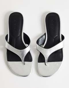 Model wearing Sisi toe thong flat sandal in silver