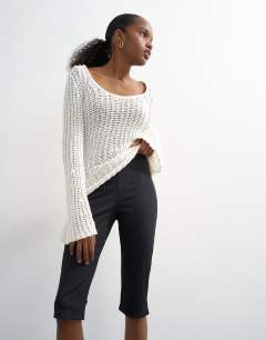 Model wearing Skinny rib flared capri trouser in black