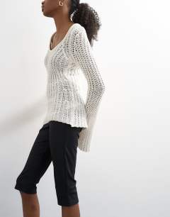 Model wearing Skinny rib flared capri trouser in black