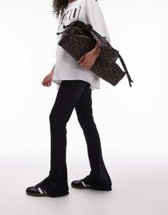 Model wearing Skinny rib flared trouser in black