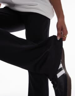 Model wearing Skinny rib flared trouser in black