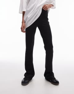 Model wearing Skinny rib flared trouser in black