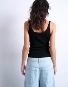 Model wearing Skinny strap scoop rib vest in black