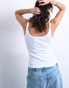 Model wearing Skinny strap scoop rib vest in white