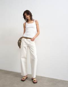 Model wearing Skinny strap scoop rib vest in white
