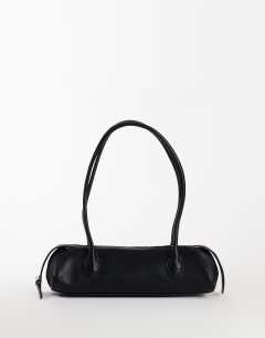 Model wearing Skylar medium elongated bowler bag in black