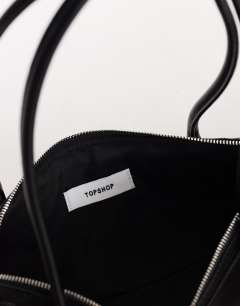 Model wearing Skylar medium elongated bowler bag in black