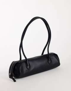 Model wearing Skylar medium elongated bowler bag in black