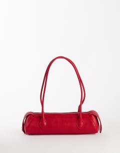 Model wearing Skylar medium elongated bowler bag in red