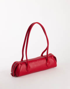 Model wearing Skylar medium elongated bowler bag in red