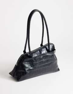 Model wearing Skyler large angular shoulder bag in black croc