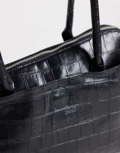 Model wearing Skyler large angular shoulder bag in black croc