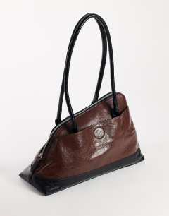 Model wearing Skyler large angular shoulder bag in chocolate and black