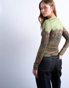 Model wearing Slash neck abstract placement print microfibre top in green