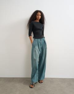 Model wearing Slash neck curve hem top in black