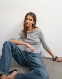 Model wearing Slash neck curve hem top in grey marl