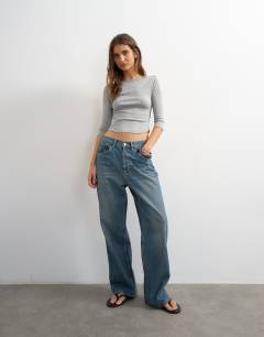 Model wearing Slash neck curve hem top in grey marl