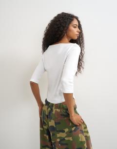 Model wearing Slash neck curve hem top in white
