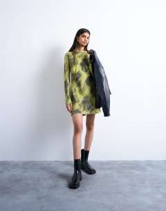 Model wearing Slash neck mini dress in blurry green print