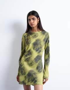 Model wearing Slash neck mini dress in blurry green print