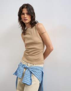 Model wearing Slash neck racer vest in stone