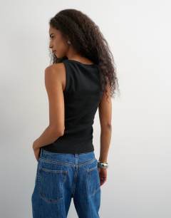 Model wearing Slash neck racer vest in washed black