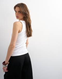 Model wearing Slash neck racer vest in white