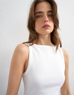 Model wearing Slash neck racer vest in white