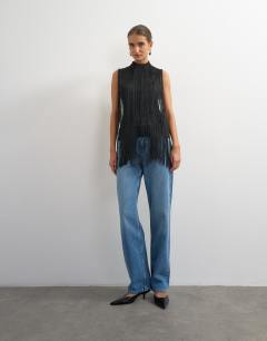 Model wearing Slash neck sleeveless fringe top in black
