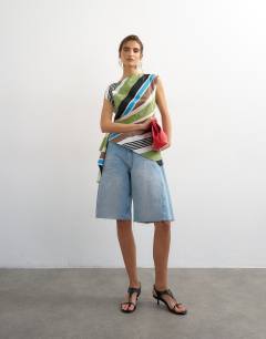 Model wearing Slash neck twist side top in green stripe