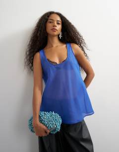 Model wearing Sleeveless organza scoop vest in cobalt blue