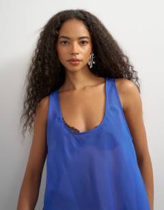 Model wearing Sleeveless organza scoop vest in cobalt blue