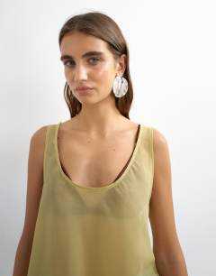 Model wearing Sleeveless organza scoop vest in muted lime