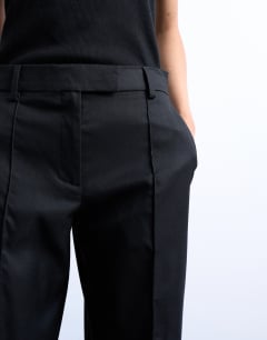 Model wearing Slim straight leg mid rise suit trouser co ord in black