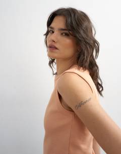 Model wearing Slim tank in peach
