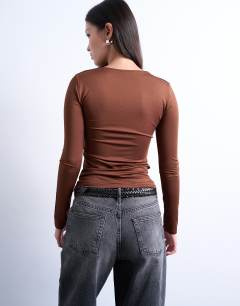 Model wearing Slinky crew neck long sleeve top in brown
