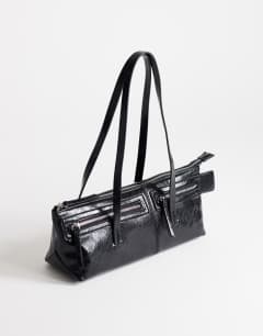 Model wearing Snoopy small zip front pocket shoulder bag in black