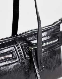 Model wearing Snoopy small zip front pocket shoulder bag in black