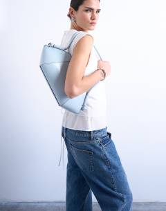 Model wearing Sofia shoulder bag in blue