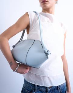Model wearing Sofia shoulder bag in blue