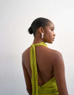 Model wearing Soft funnel halter neck top in green check