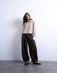 Model wearing Soft touch boxy long sleeve polo in taupe